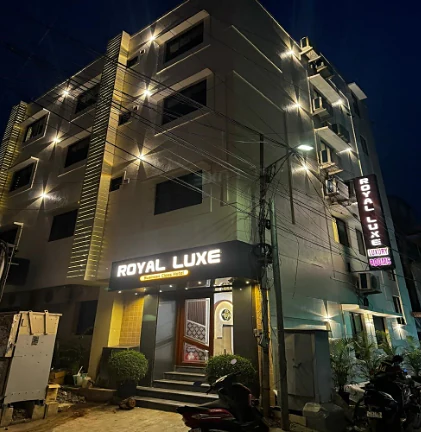 Hotel Royal Luxe lit up at night in Thousand Lights West