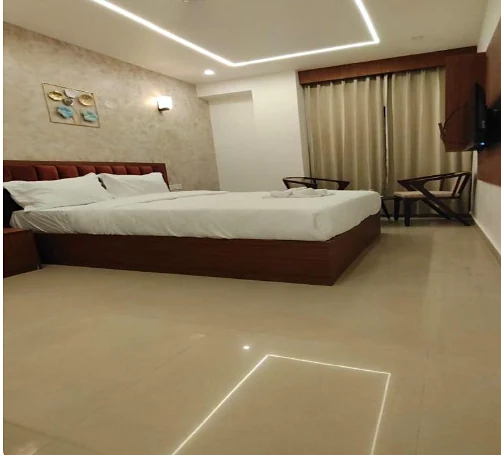 Deluxe Double room with a maroon headboard at Hotel Royal Luxe