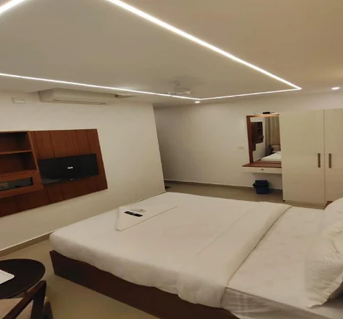 Cove-lit ceiling and TV unit in a Deluxe Double room at Hotel Royal Luxe